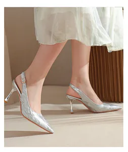 Side view of elegant silver glitter pointed-toe slingback pumps with slim high heels