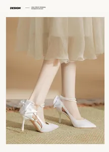Elegant white satin bridal high heels featuring a pearl ankle strap and satin bow