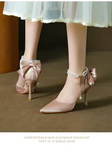 Detailed view of champagne satin stiletto heels with elegant pearl anklet strap