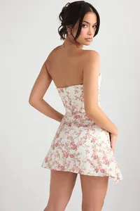 Detailed back view of a slim-fit floral mini dress with an elegant open-back design.