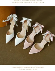 Elegant pointed toe stiletto high heels featuring satin bows and pearl ankle straps