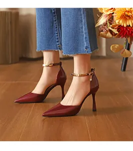 Elegante rote Lackleder-Pumps mit spitzer Zehenpartie und goldenen Knöchelriemen.