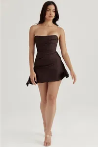 Full-length view of a model in a brown strapless corset-style satin mini dress for evening.