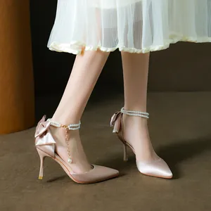 Elegant champagne pink satin pointed toe high heels with bow and pearl ankle strap