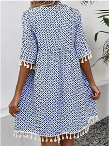 Back view detail of bohemian blue geometric print dress with tassel hem and sleeves