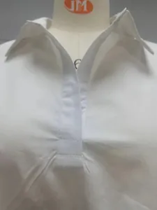 Gros plan détaillé du col et du décolleté professionnel sur une robe chemise blanche