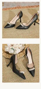 Elegant black pointed toe stiletto pumps featuring decorative pearl and gold chain strap.