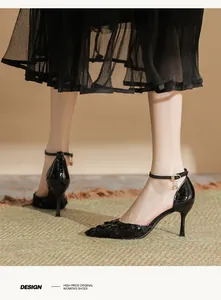 Side view of elegant black sequined pointed-toe stilettos with delicate ankle straps
