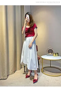 Detailed view of red patent leather pointed-toe stilettos with knot decoration