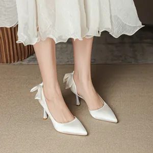 Eleganti décolleté d'Orsay in raso bianco con fiocchi posteriori e tacchi a spillo.