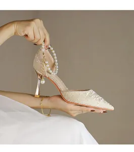 Elegant champagne pointed-toe high heels with pearl ankle strap and lace texture