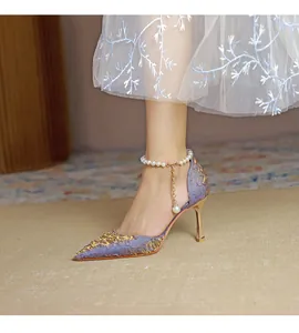 Elegant purple and gold brocade pointed-toe stiletto heels with luxury pearl anklet.