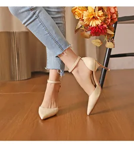 Elegant beige crocodile-embossed pointed-toe stiletto pumps with ankle straps on a model
