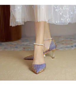 Elegant purple floral pointed toe pumps with decorative pearl ankle strap detail.