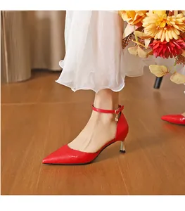 Side view of elegant red crocodile pattern pointed-toe kitten heels with ankle strap.