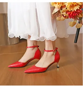 Elegant red crocodile pattern pointed heels with ankle strap shown on foot.