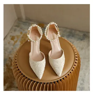 Elegant pointed-toe pumps with pearl ankle straps and floral texture stiletto heels.
