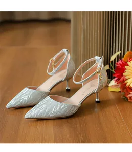 Tacones bajos de purpurina plateada con punta afilada, tira al tobillo y dije de cristal