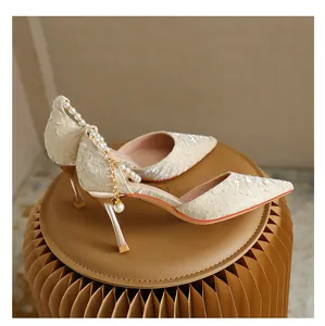 Elegant champagne textured pointed toe stiletto heels with decorative pearl ankle strap
