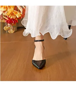 Elegant black crocodile embossed pointed-toe high heels with an adjustable ankle strap.