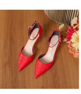 Close-up view of red crocodile-embossed pointed toe high heels with an elegant ankle strap.