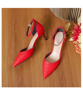 Detailed macro view of red crocodile pattern on elegant pointed-toe stiletto heels