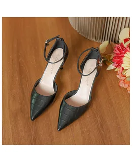 Elegant black crocodile-patterned pointed-toe pumps with delicate thin ankle straps.