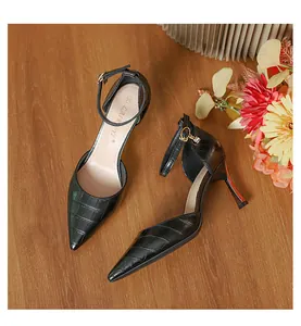 Detailed view of elegant black crocodile pattern pointed-toe stiletto heels with ankle strap