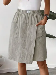 Close-up front view of casual light grey skorts featuring elastic waist and dual pockets.