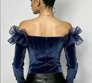 Detailed back view of a navy blue off-the-shoulder velvet blouse with ruffled sleeves