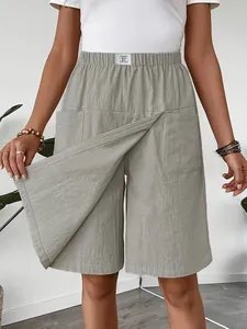 Detailed view of sage green casual culottes with front overlap panel and elastic waistband