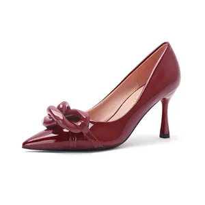 Elegant burgundy patent leather pointed toe stiletto pumps with a stylish chain detail
