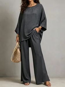 Detail view of a charcoal grey cotton linen two-piece set with wide-leg trousers