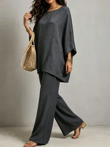 Full view of women's grey cotton linen two-piece set showing elegant drape and texture