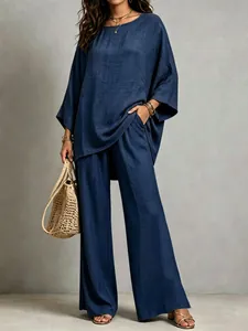 Detail view of navy blue cotton-linen blend tunic and wide-leg trousers with pocket.