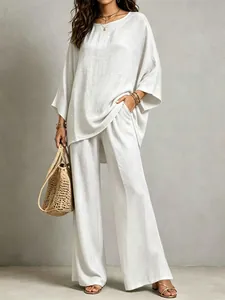 Two-piece cotton linen set featuring a loose tunic and wide-leg trousers with pockets