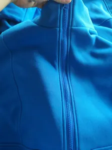 Close-up detail of bright blue fleece zip-up hoodie with high quality plastic zipper