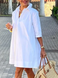 Vue détaillée d'une robe chemise blanche évasée en ligne A avec manches mi-longues.