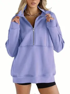 Detailed shot of oversized purple half-zip fleece sweatshirt for women's winter wear.