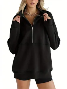 Detail view of the oversized black fleece quarter-zip sweatshirt showing collar and fit