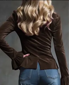 Back view of brown velvet pullover featuring flare sleeves and delicate ruffle cuffs