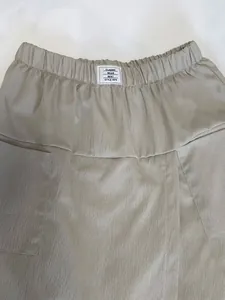 Close-up detail of casual women skort featuring elastic waistband and pleated fabric