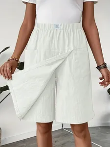Close-up of white high-waisted casual shorts skirt with pockets and layered design