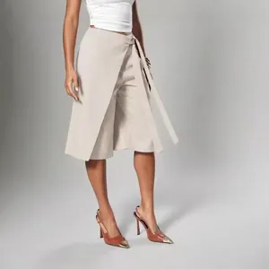 Detailed view of women's beige wrap tie-waist culottes with an elegant wide-leg design