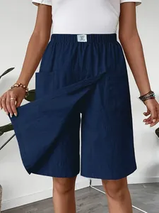 Detail view of navy blue casual skort showing the overlapping skirt panel and pockets.