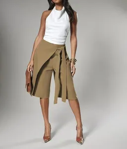 Stylish khaki wrap-style belted skort with white halter top for elegant commuter look