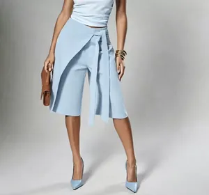 Fashionable light blue wrap-around tie-waist culottes shown on a model in a studio setting