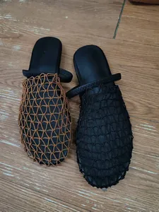 Detailed view of summer hollow mesh woven closed-toe slippers in black and brown