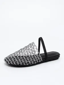 Silver mesh woven flat mules featuring a breathable net design and black elastic back strap.
