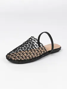 Detailed view of the intricate black mesh woven pattern on summer flat slippers